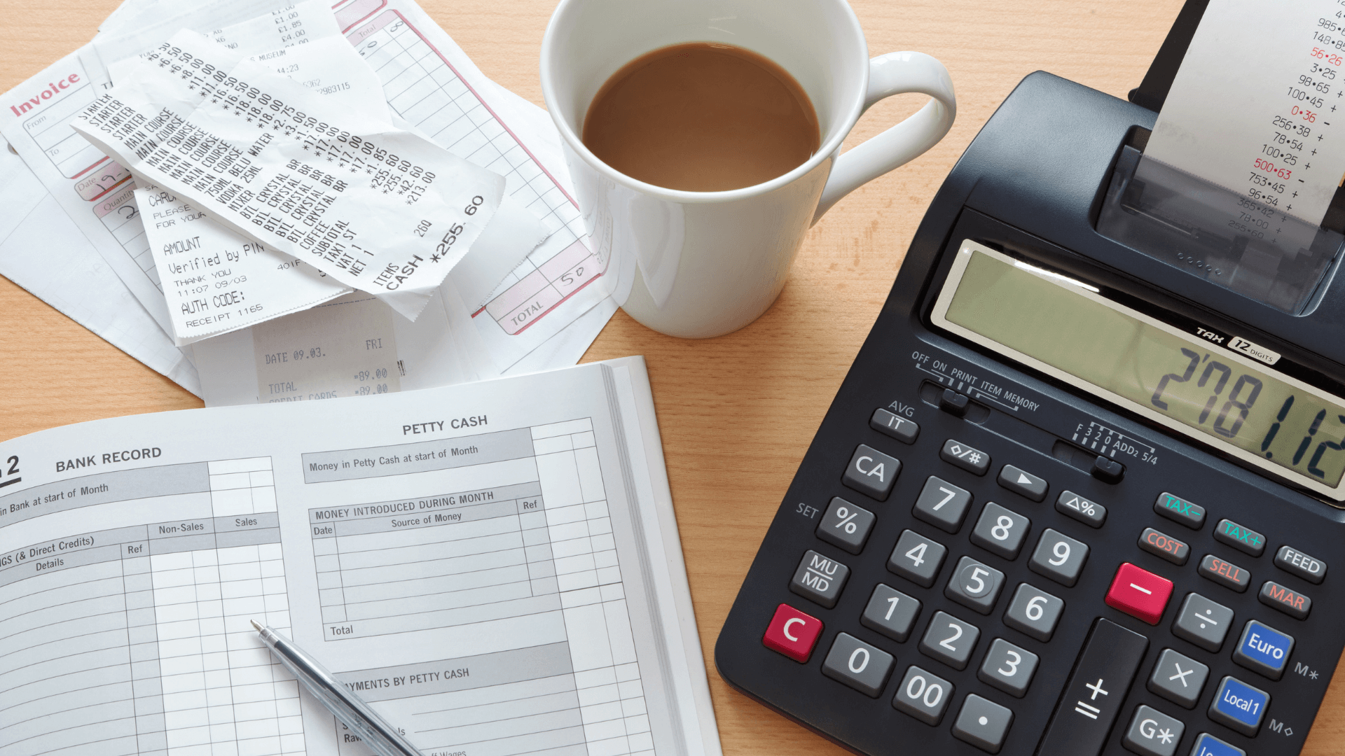 3 Benefits of Hiring a Bookkeeper * Hiring a bookkeeper - calculator, mug of tea, receipts