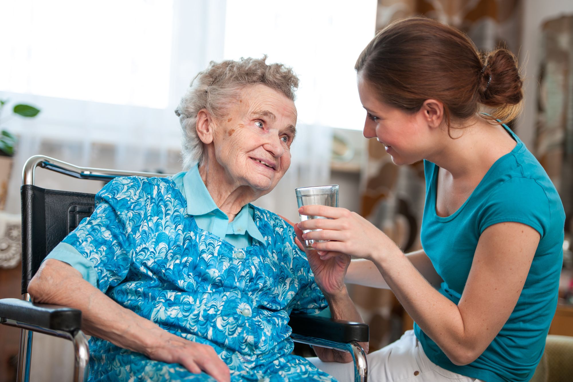 What Is Home Health Care and Who Qualifies For It? * home-health-care-carer-giving-lady-pills