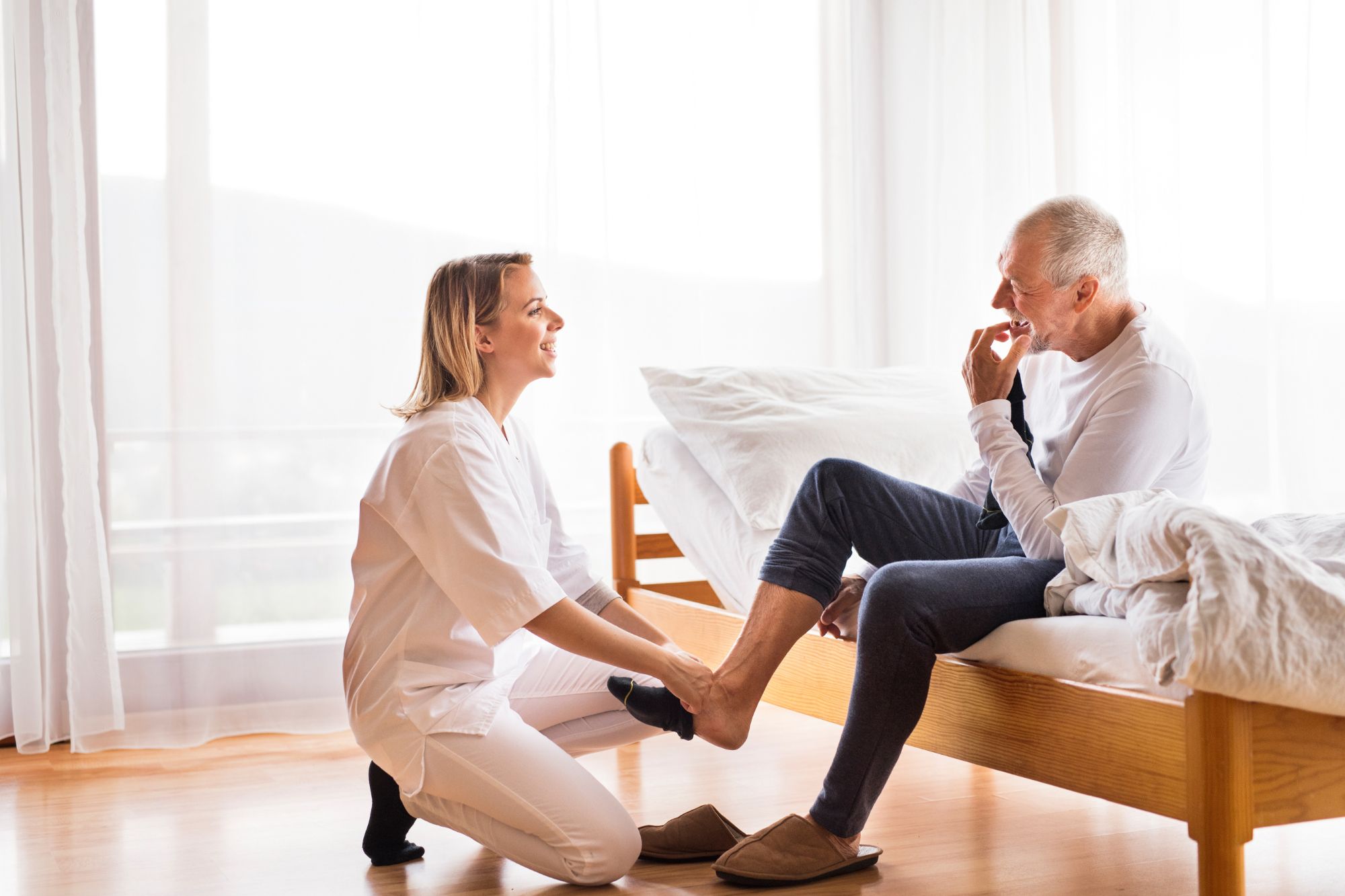 What Is Home Health Care and Who Qualifies For It? * home-health-care-carer-putting-shoes-on-man