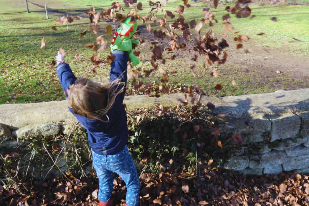12 Easy and Fun Tips For Gardening With Kids gardening-with-kids-throwing-leaves