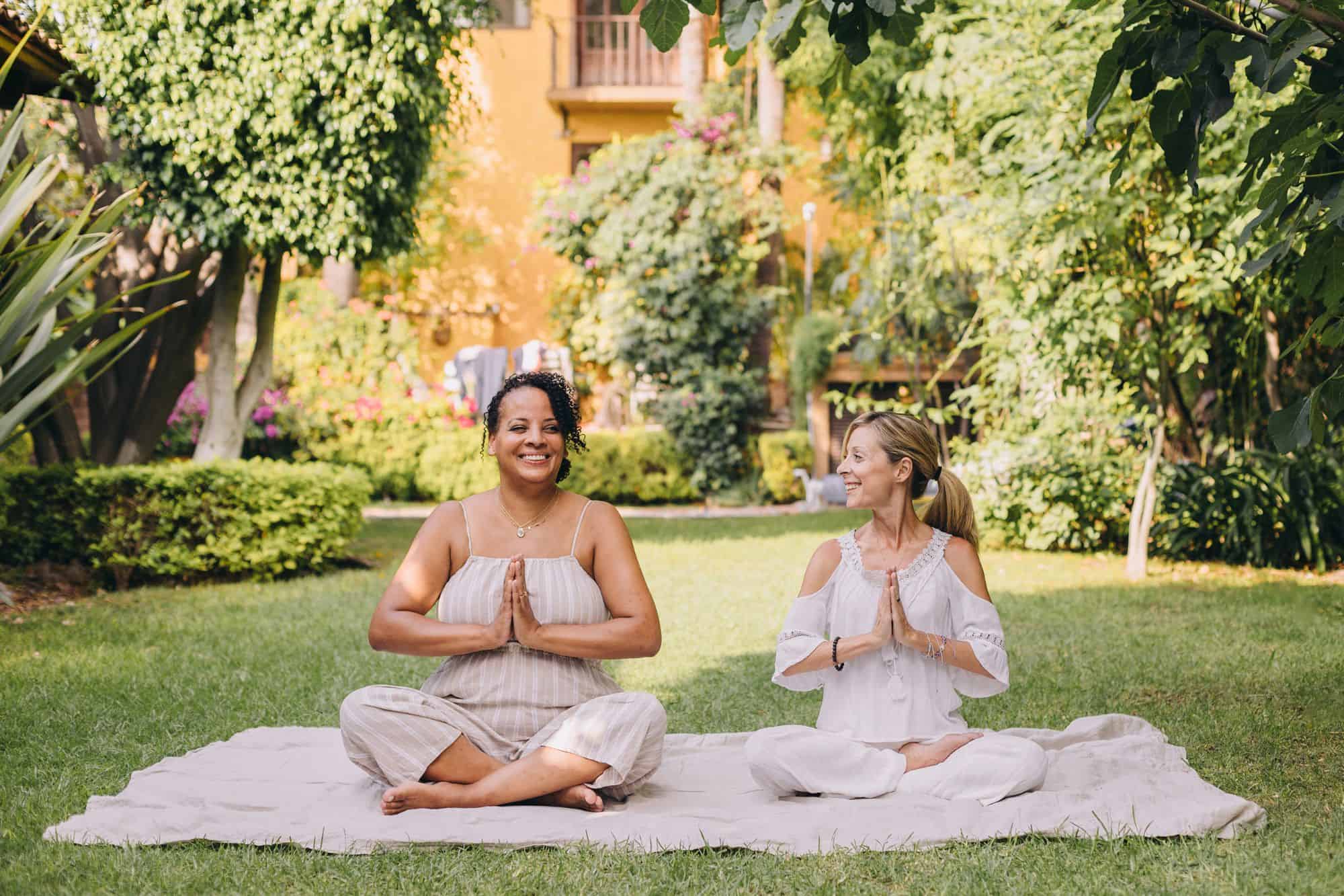20 New Year Rituals of Renewal to Help You Rediscover Yourself * new-year-rituals-of-renewal-two-women-yoga-outside